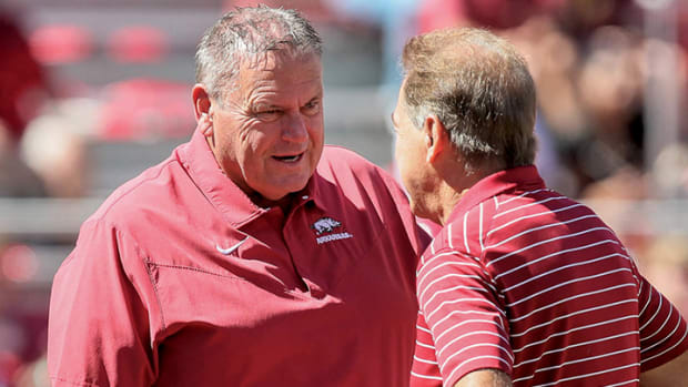 Arkansas Razorbacks coach Sam Pittman talks to Alabama Crimson Tide coach Nick Saban prior to the game at Razorback Stadium.